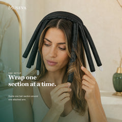 Woman wrapping one hair section around an attached black curling arm.