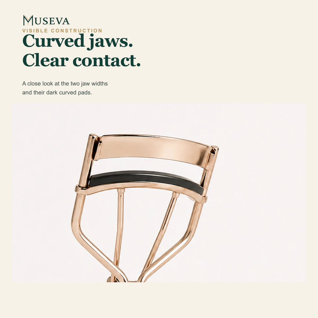 Close-up of the curved jaws and dark pads on the wide eyelash curler.