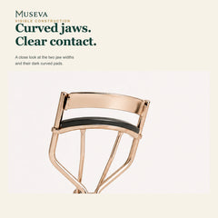 Close-up of the curved jaws and dark pads on the wide eyelash curler.