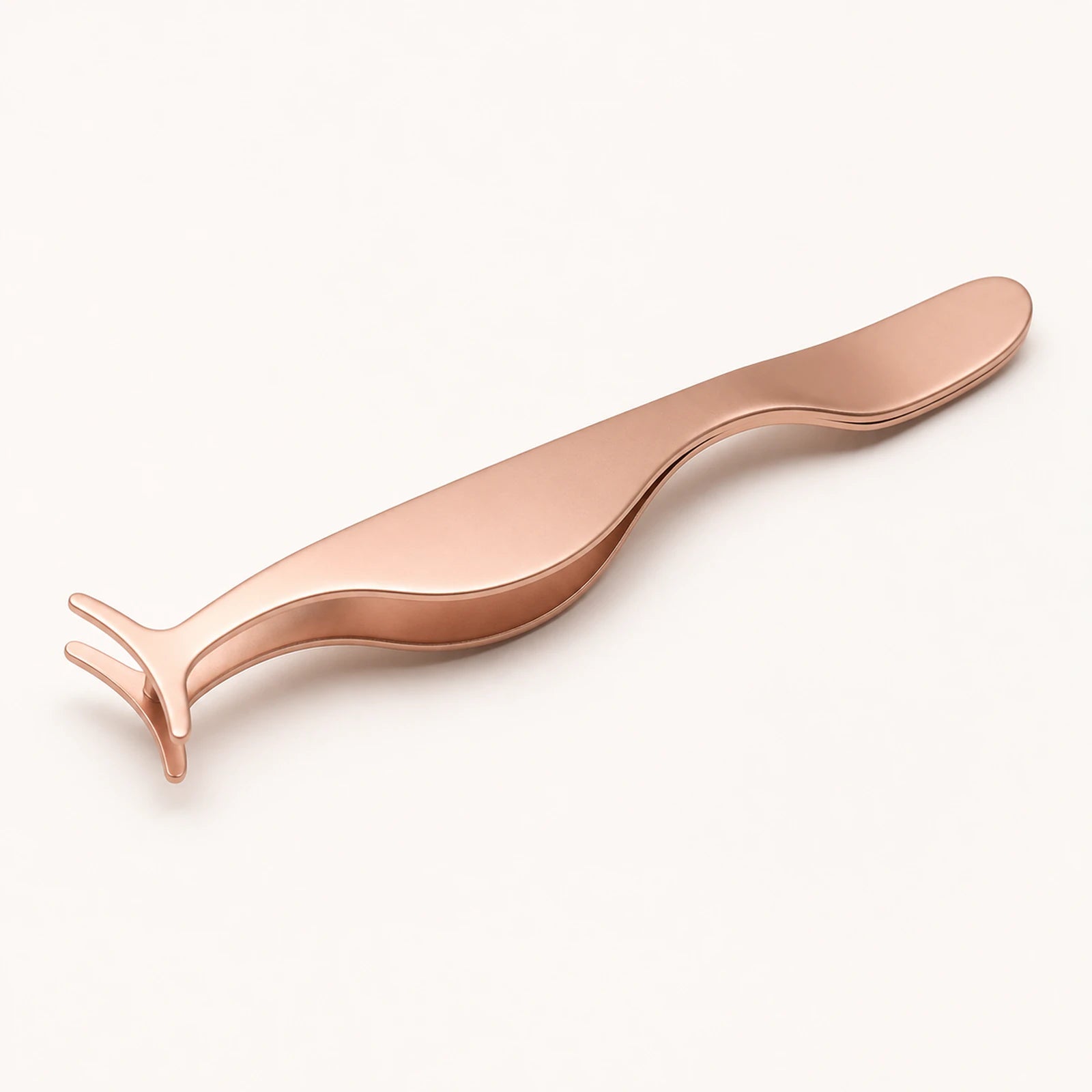 The Curved Lash Applicator on warm ivory with the headline Lash Placement, In Hand.