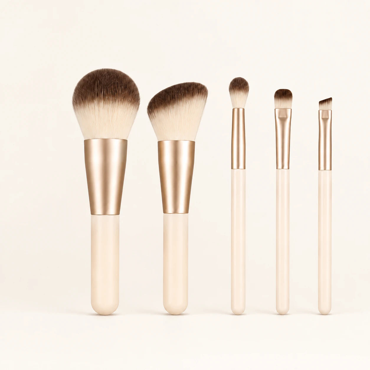 Woman using one small MUSEVA brush at the outer eyelid with four brushes on a tray.